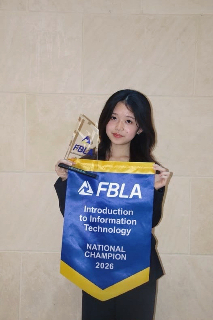 Penny Zhu with the 2026 FBLA Introduction to Information Technology National Champion banner and trophy.